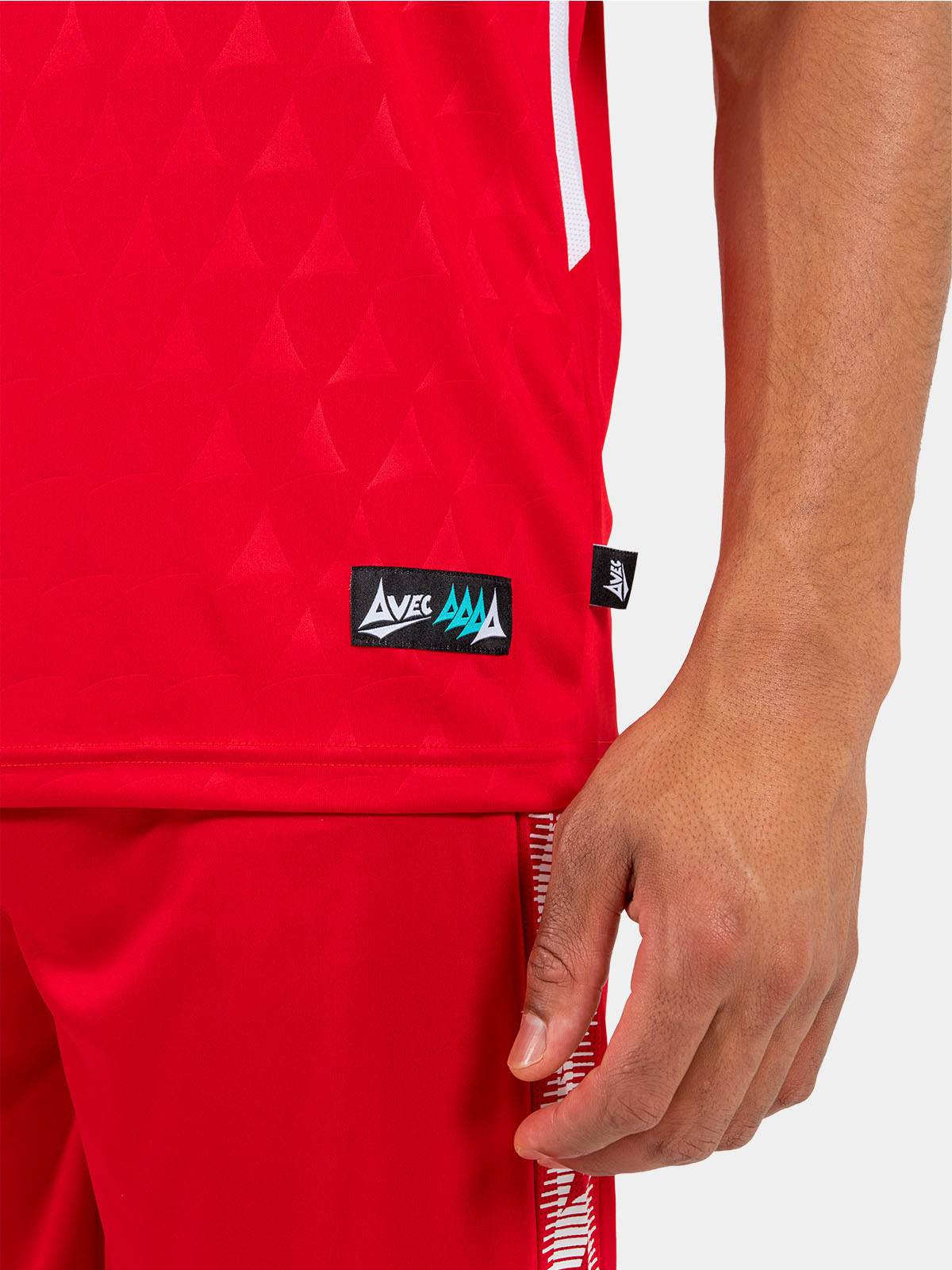 close-up of the red jersey hem, showcasing the official authentic label and mesh ventilation.