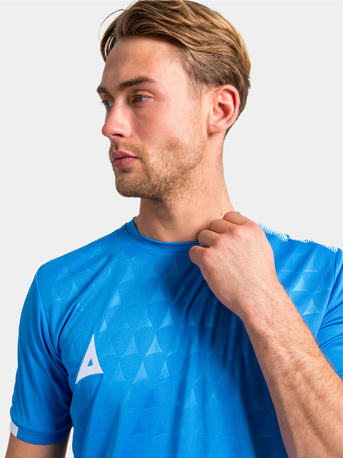 textured view of the royal blue front panel with the signature repeating debossed 'a' graphic.