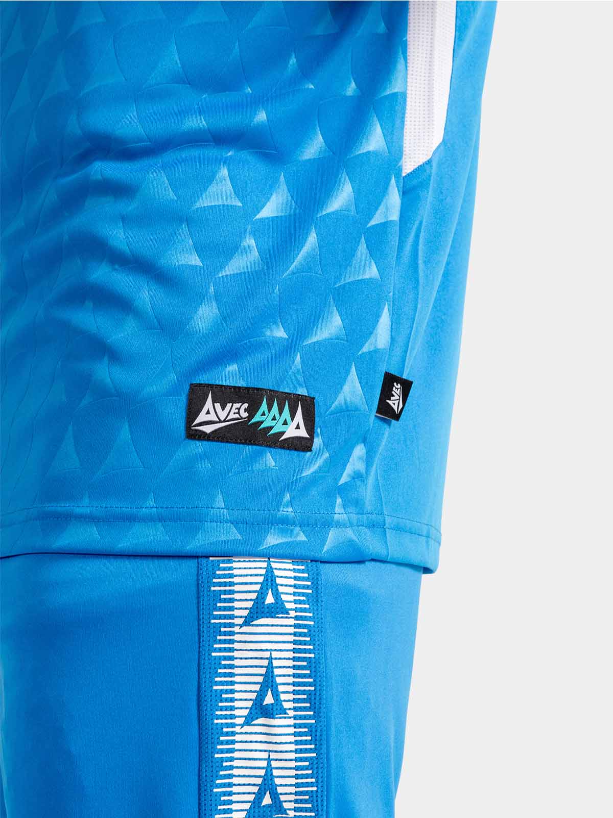detailed shot of the royal blue jersey hem, authentic id label, and breathable mesh inserts.