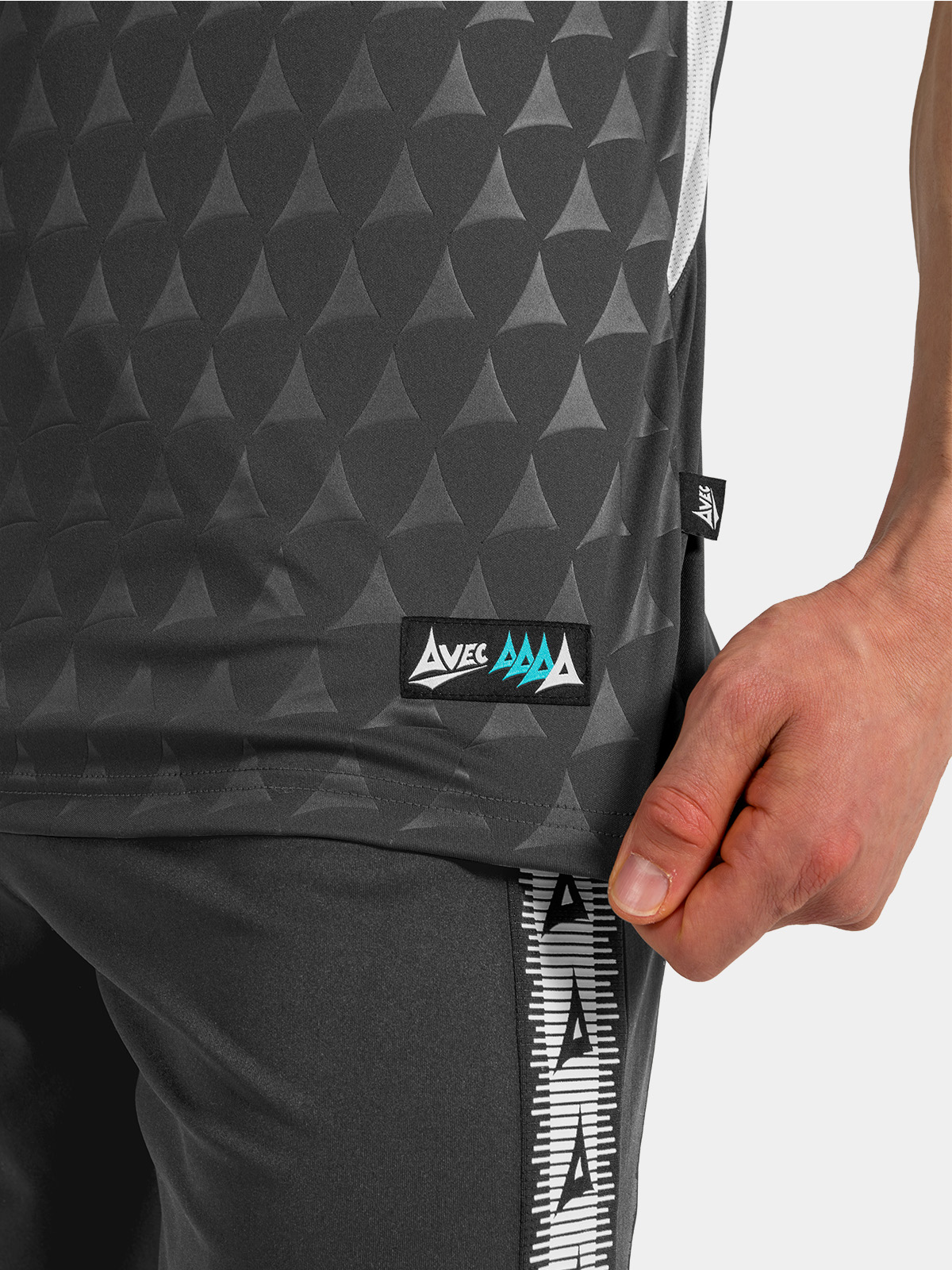 detailed view of the anthracite jersey hem, showing the mesh side-seam and authentic woven label.