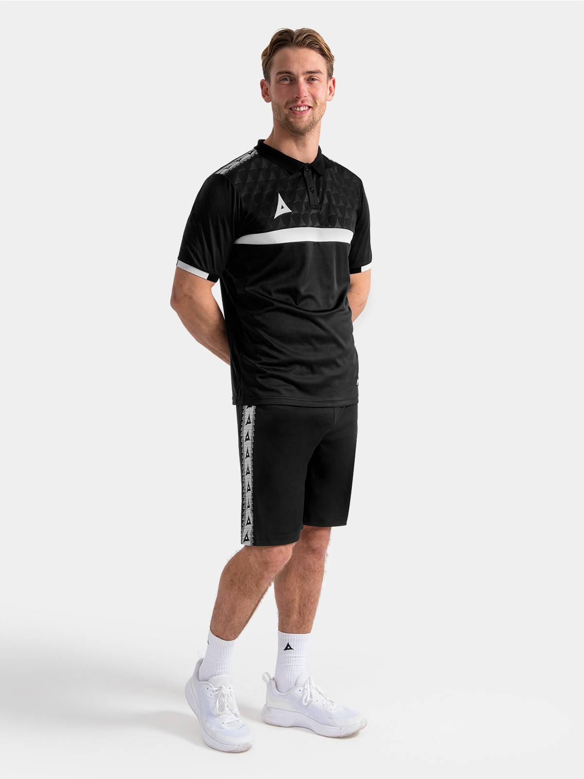 full travel kit view featuring the black pro tech polo paired with matching presentation trousers.