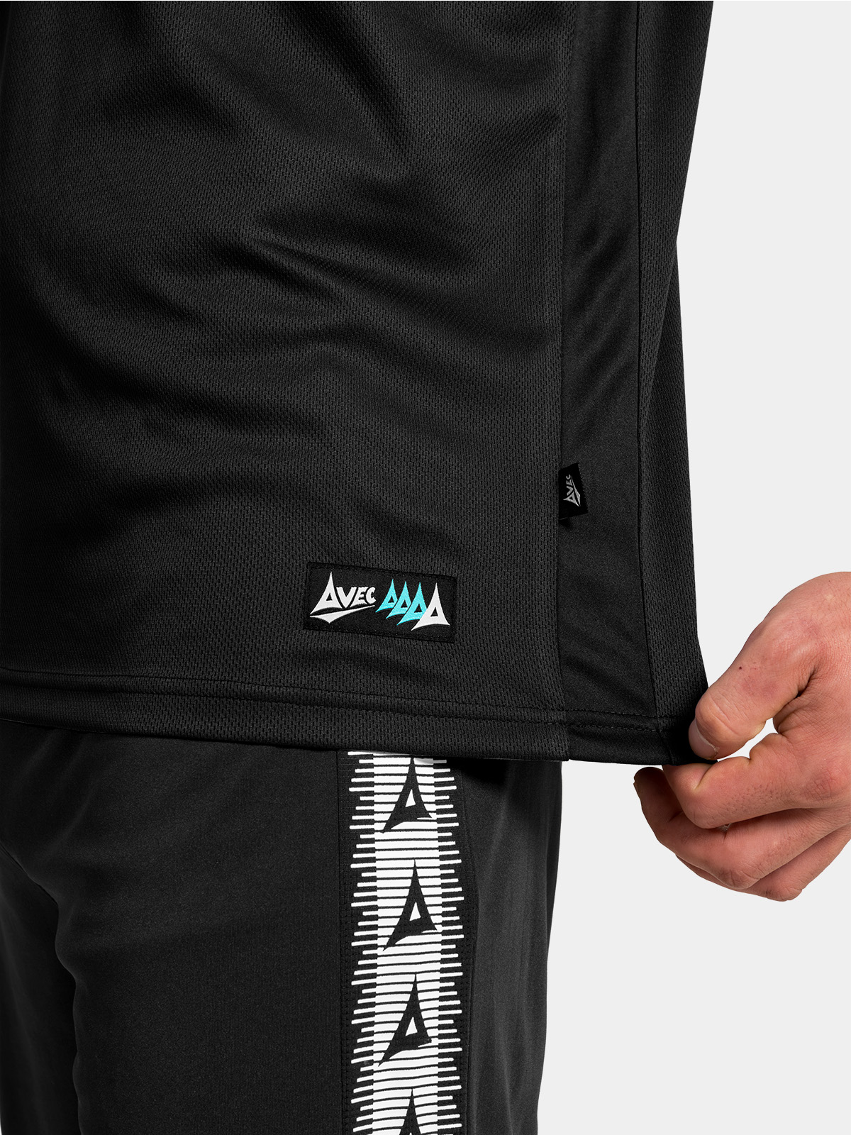 technical detail of the reinforced hem, mesh side-seam, and official woven authentic id label.