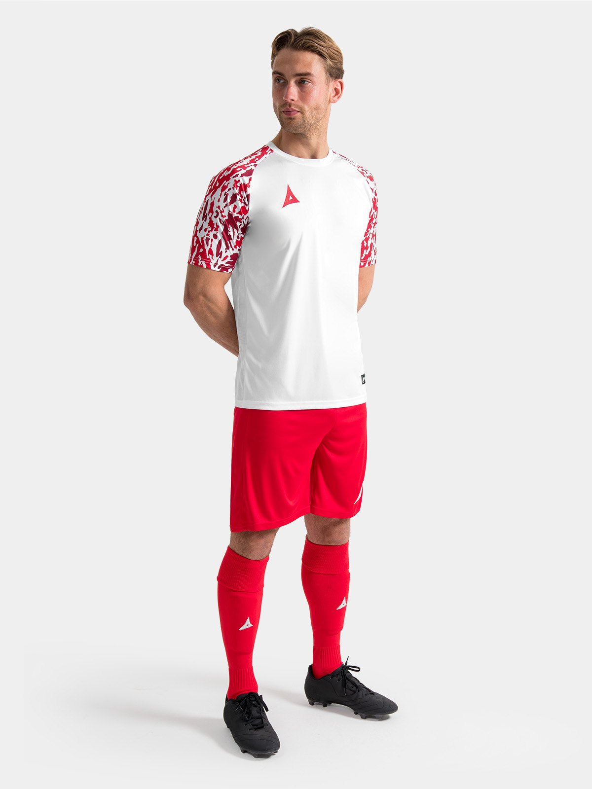 full matchday kit view featuring the white and red jersey styled with matching teamwear shorts and socks.