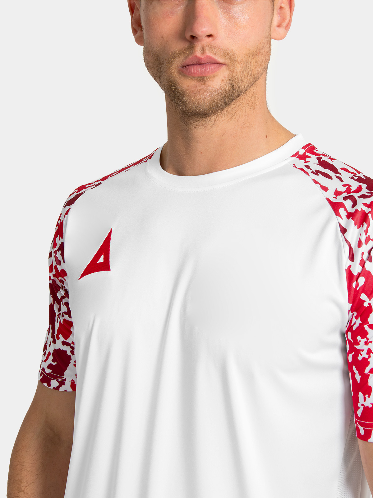 detailed shot of the reinforced round neckline and soft-feel interior branding on the white and red jersey.