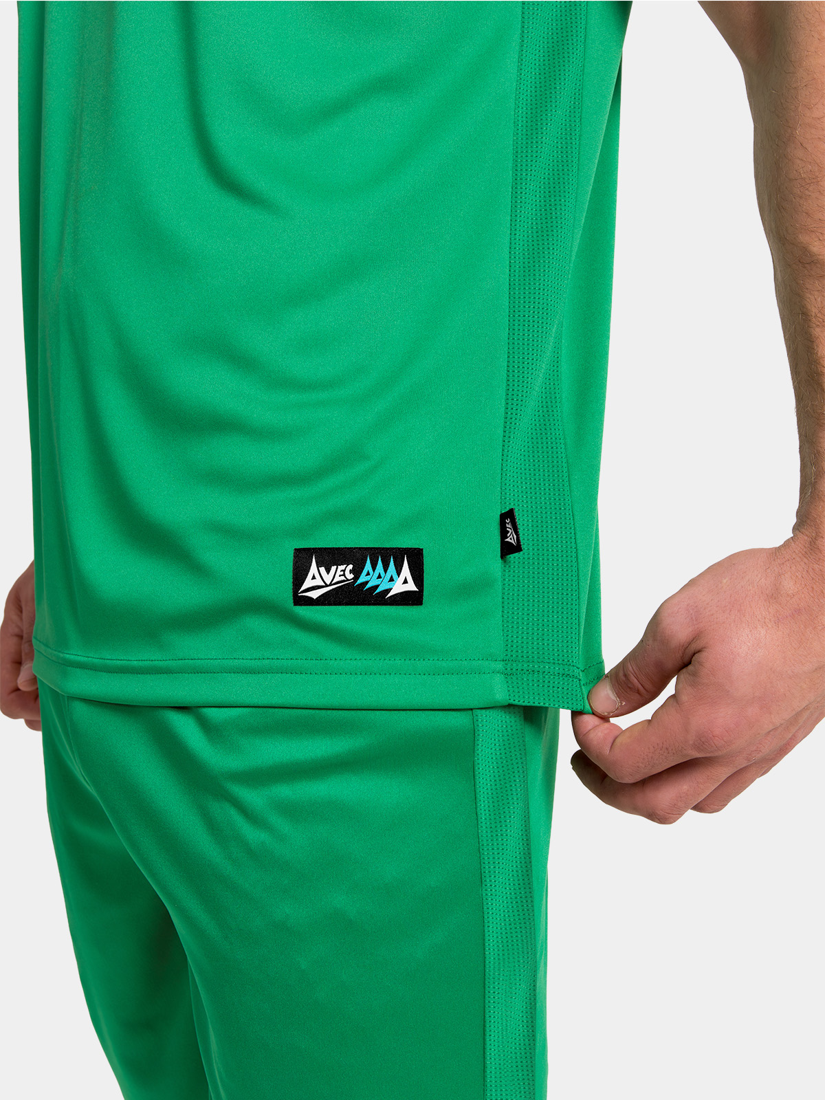 close-up of the side seam ventilation mesh and the silver authentic woven label on the green jersey