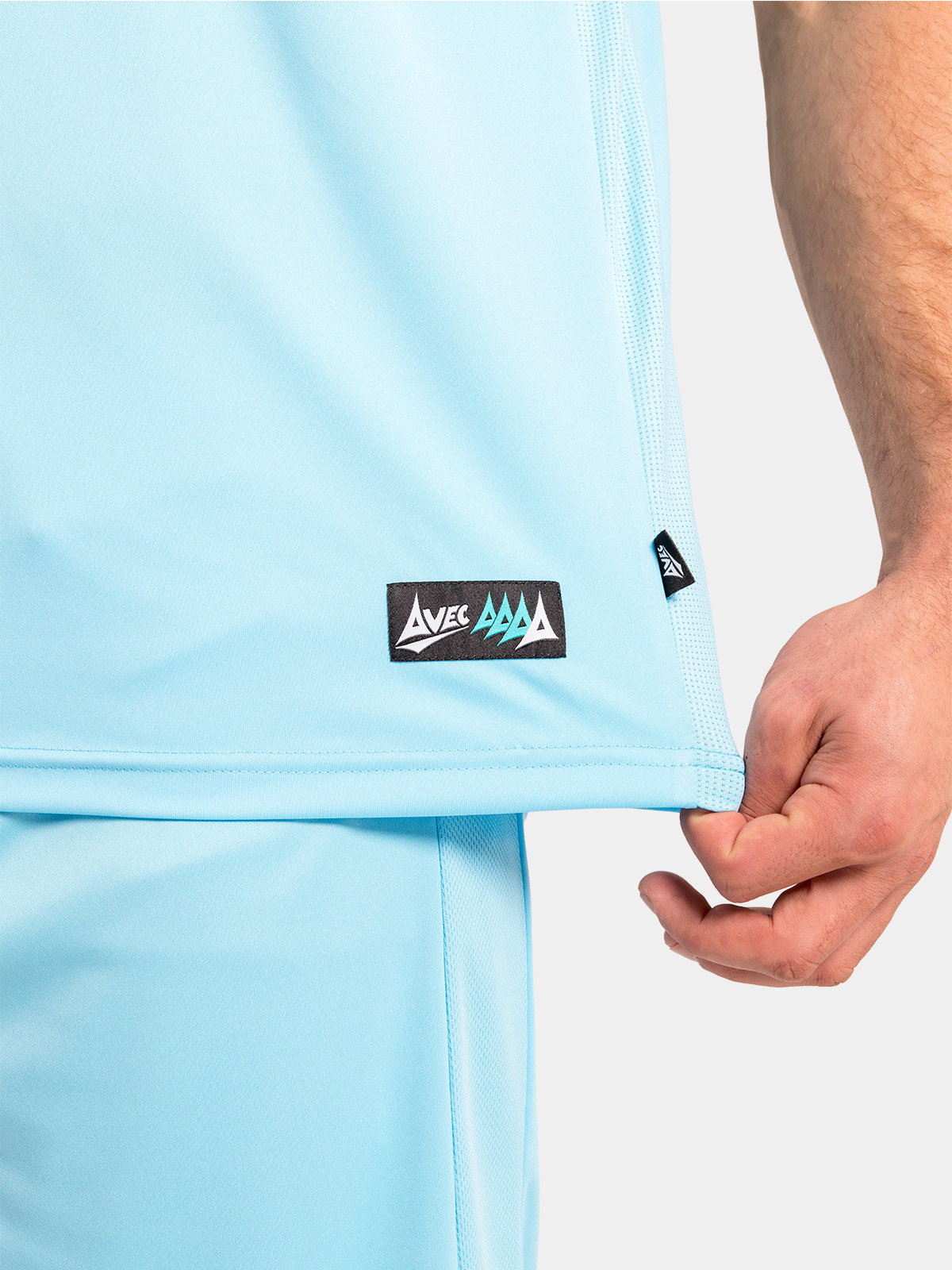 lower hem detail of the hyper sky jersey, featuring the breathable mesh ventilation and official woven authenticity label.