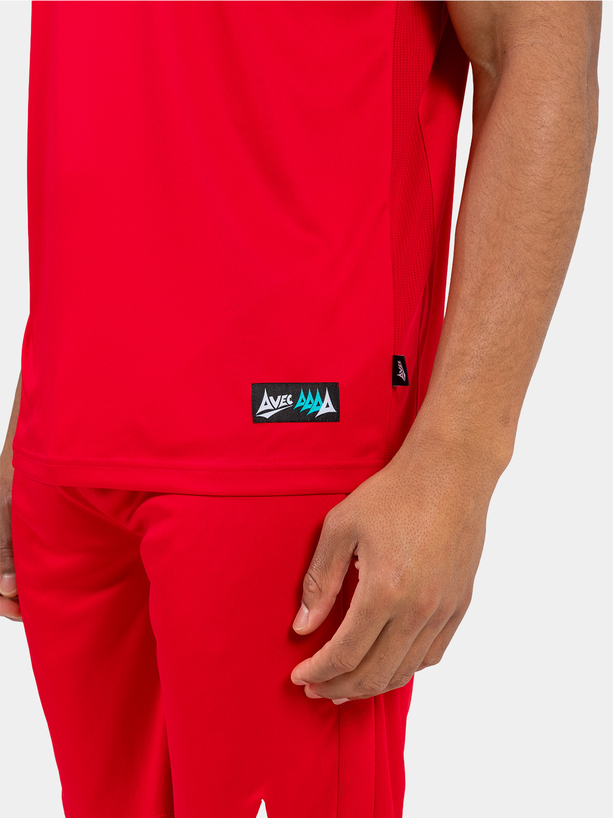 side hem view of the red jersey, showing the official authenticity label and moisture-wicking mesh.