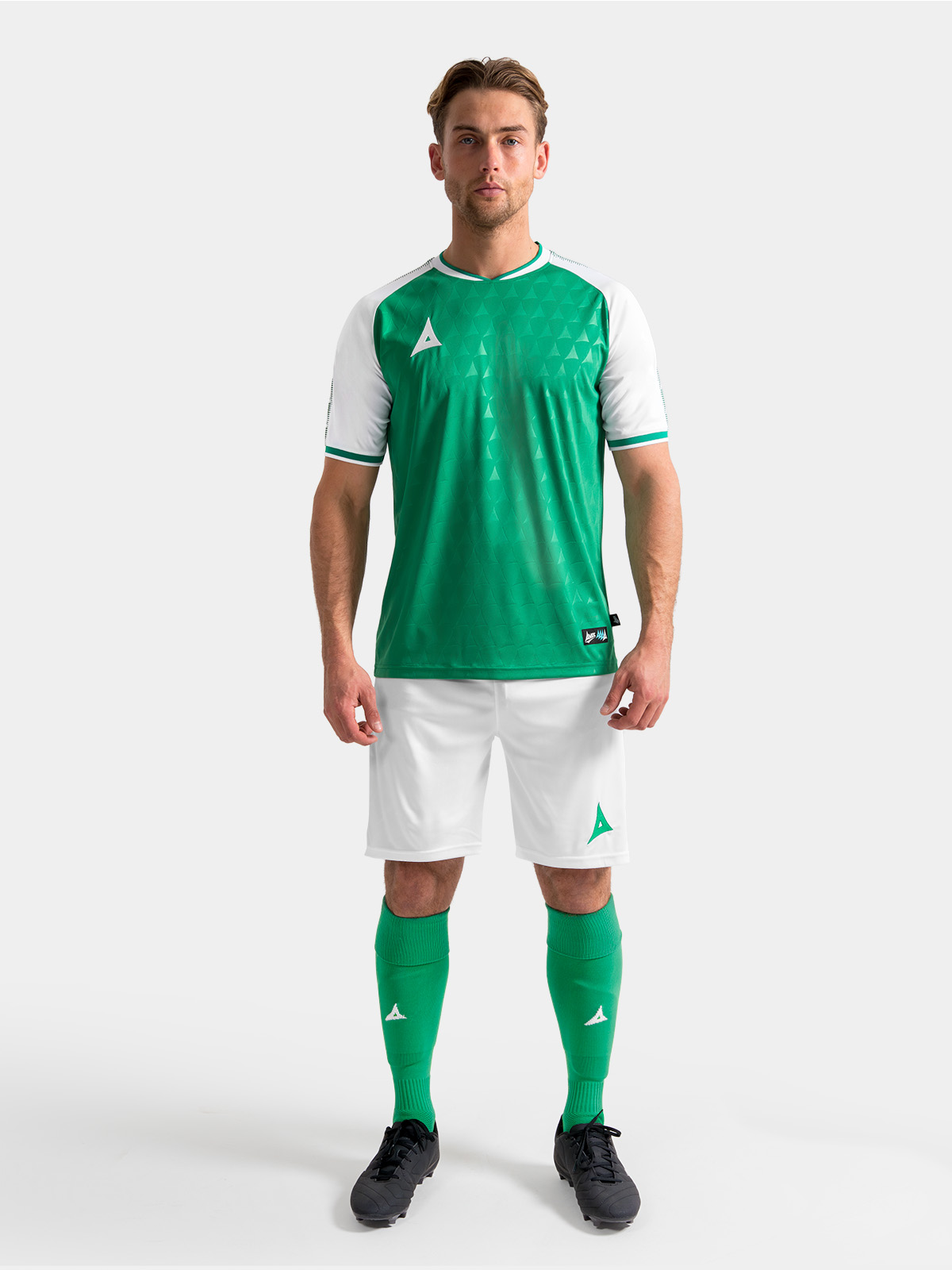 full body lifestyle view of the green and white heritage matchday kit.