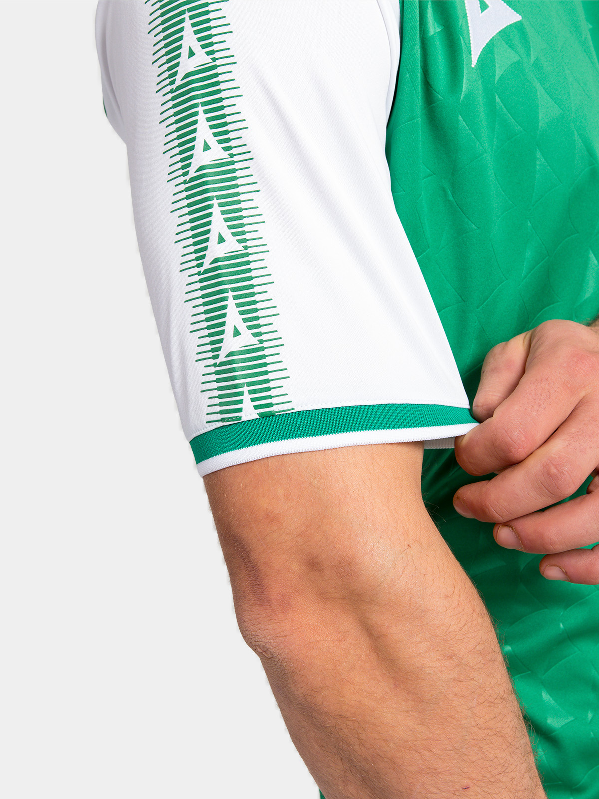 detailed close-up of the green heritage sleeve with contrast white 'a' branding.