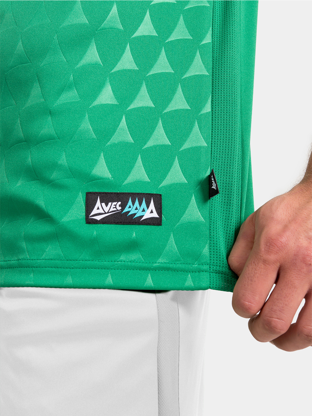 hem detail of the green heritage jersey showing the official authenticity tab.