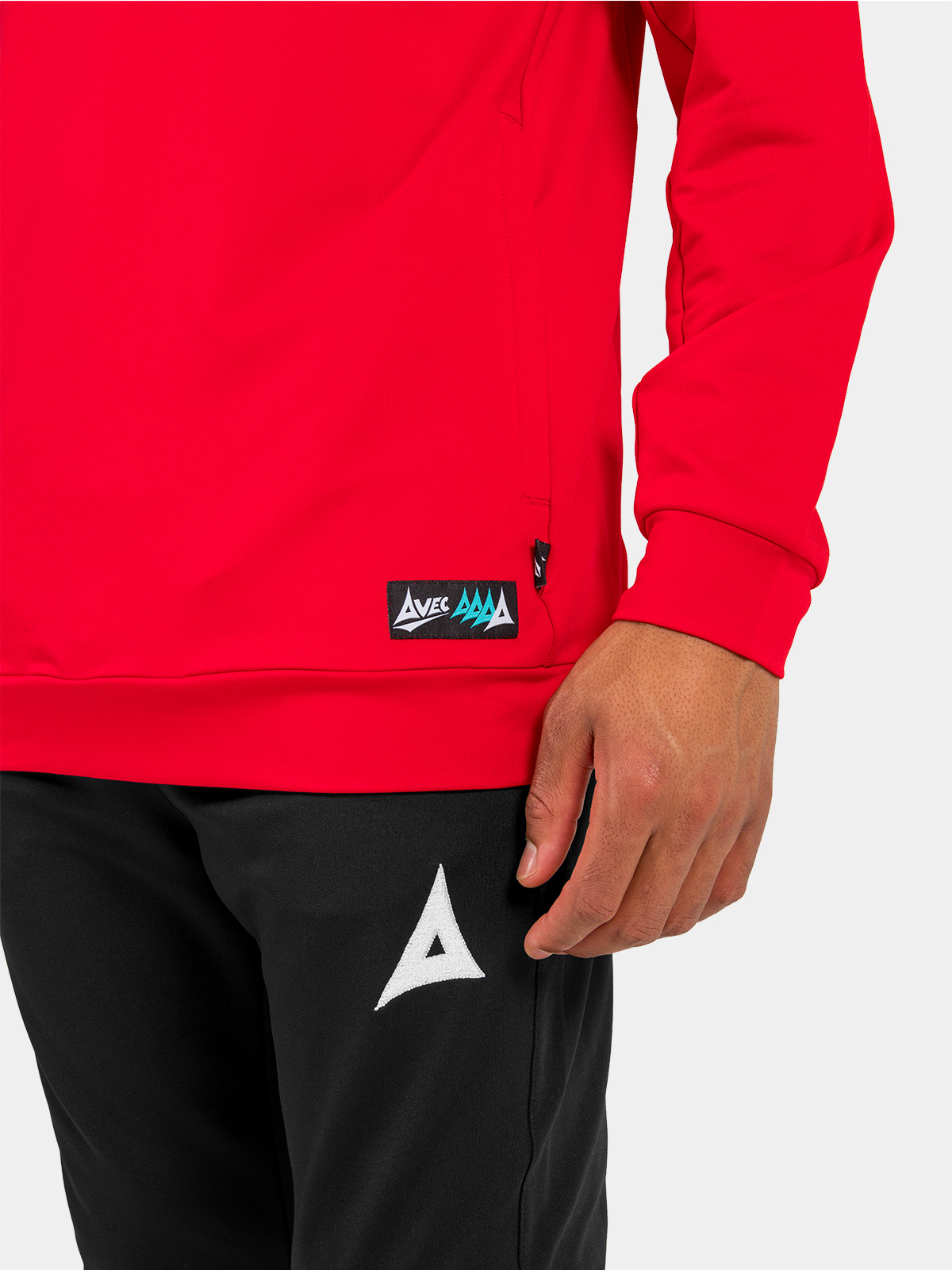 lower shot of the red hoody hem, displaying the secure zipped pocket and woven authentic id label.