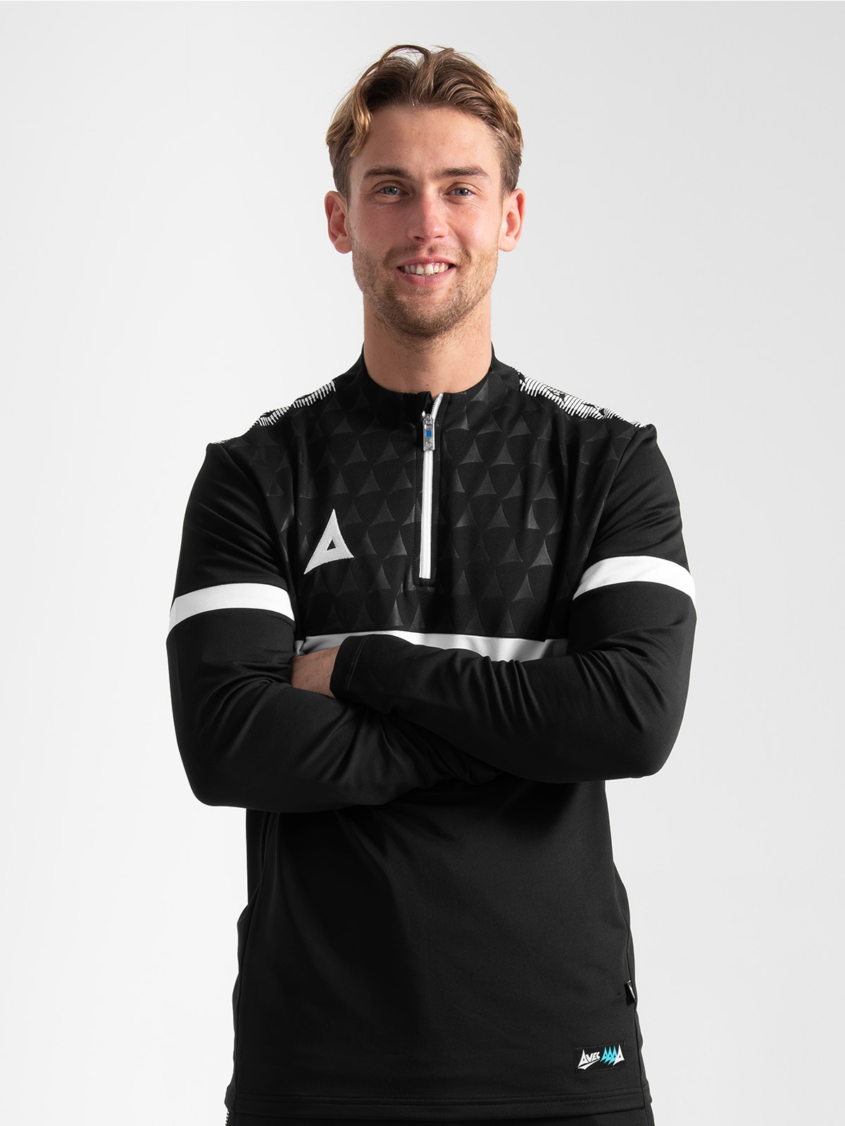 close-up of an athlete wearing the black evolve pro overlay, highlighting the professional collar height and embroidered 'a' logo.