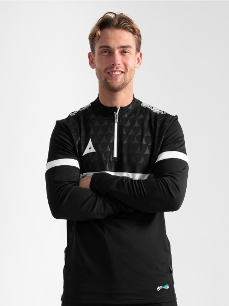 Close-up of an athlete wearing the Black Evolve Pro Overlay, highlighting the professional collar height and embroidered 'A' logo.