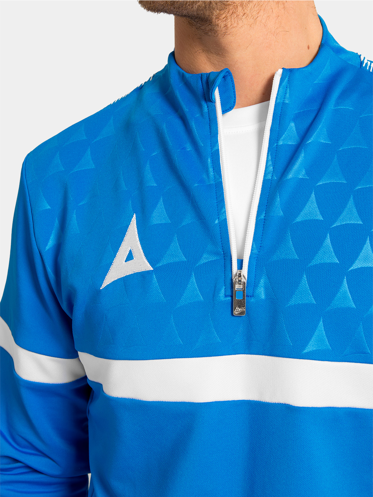 detailed view of the royal blue 1/4 zip, highlighting the debossed chest pattern and contrast shoulder taping