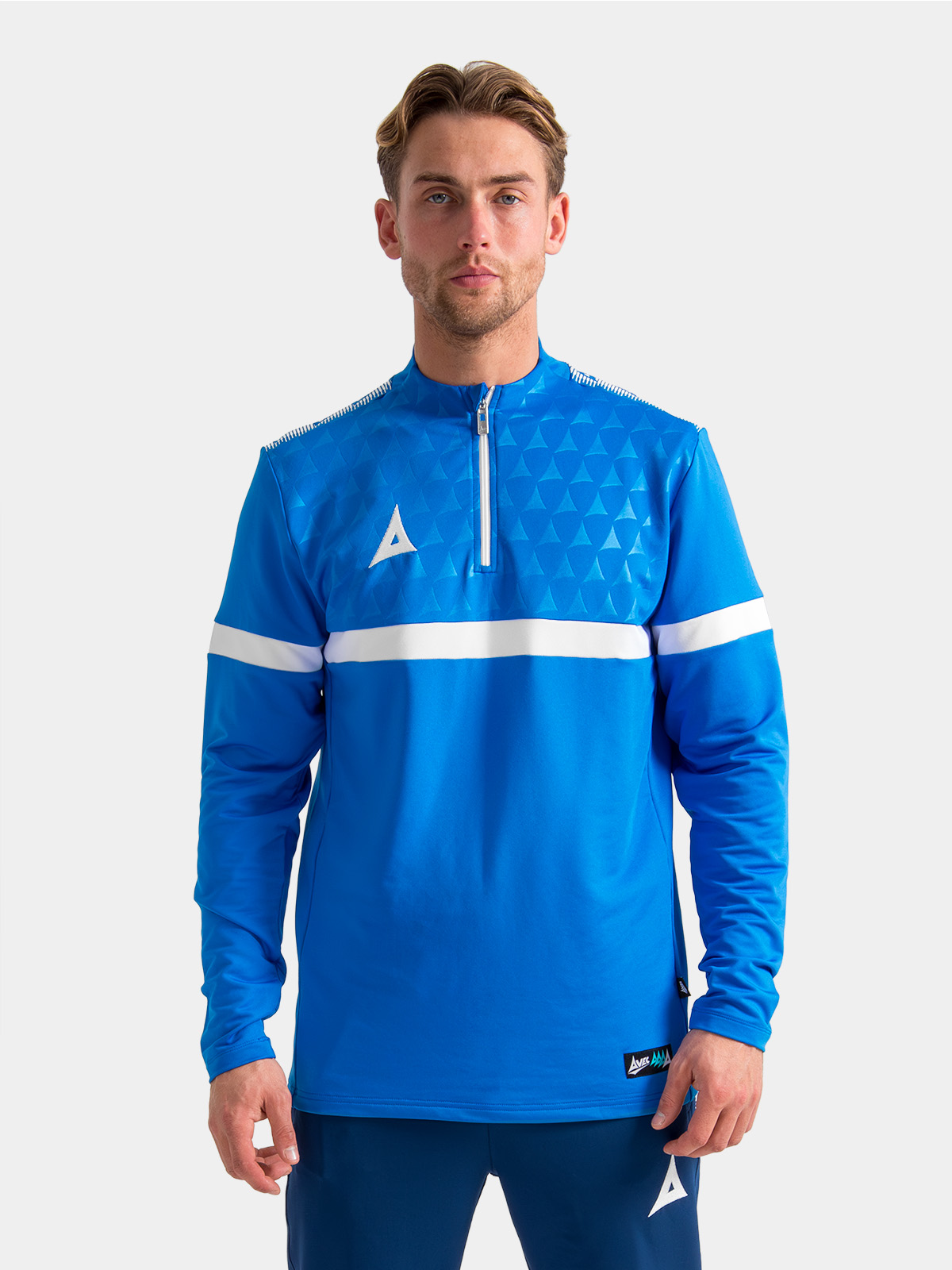 model in the royal blue evolve pro overlay, showing the athletic fit and embroidered heritage 'a' logo.