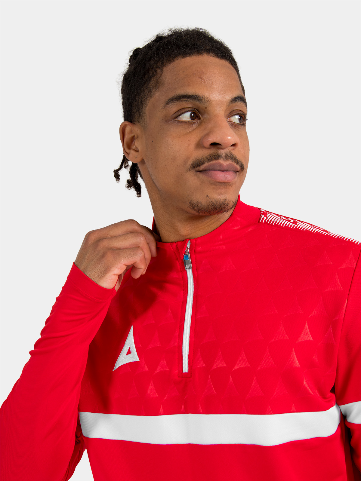 macro shot of the red 1/4 zip fully fastened, showcasing the premium zipper and protective neck coverage.