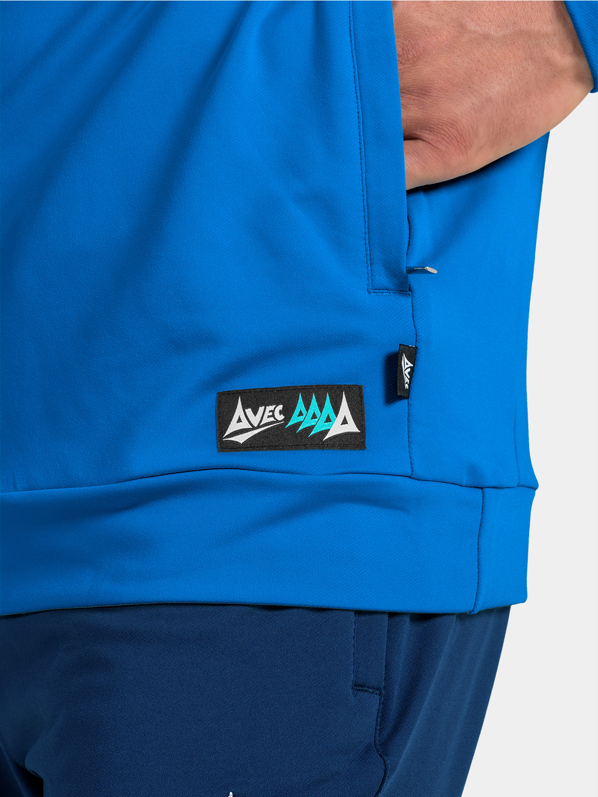 detail of the royal blue hem, featuring the secure storage pocket and woven avec sport authenticity label