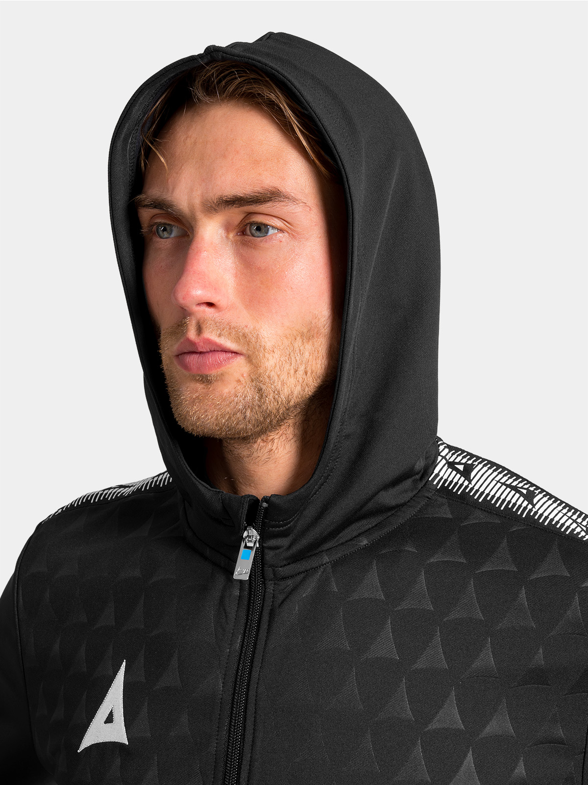 close-up of the structured hood on the black evolve pro jersey, designed for warmth and protection against the elements.