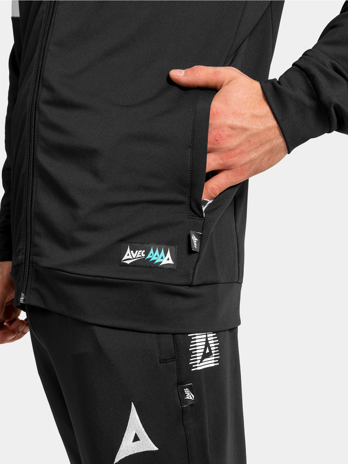 lower front detail of the black hoody, showing the secure zip pocket, reinforced hem, and official woven authentic id tag.