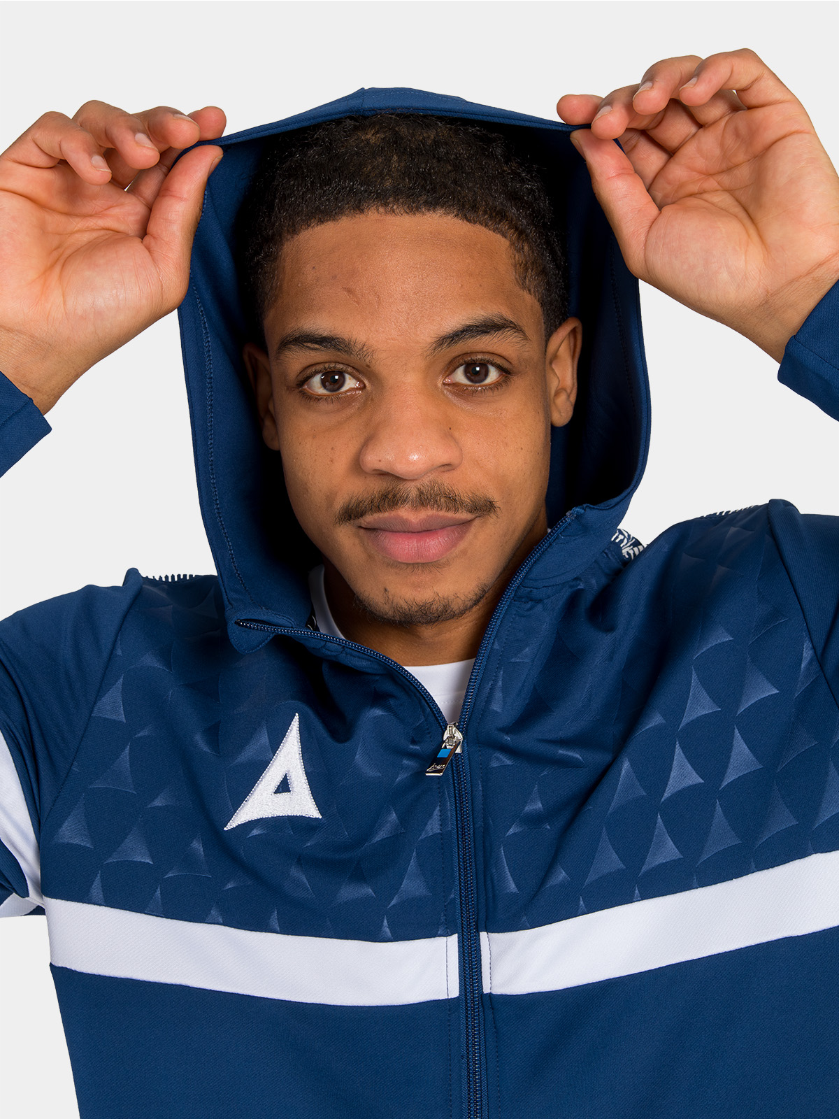 close-up of the navy technical hood, built with 88% polyester and 12% elastane for a comfortable, non-restrictive fit.