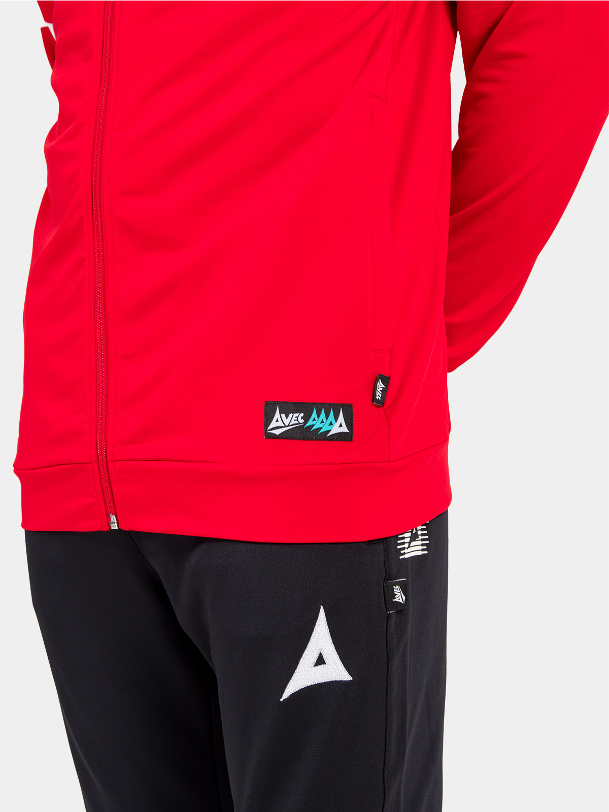 close-up of the red hoody hem, displaying the functional side pocket and official authenticity id label.