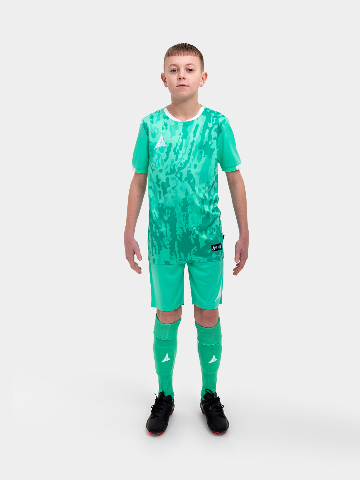 a kids football kit in mint green / hyper green