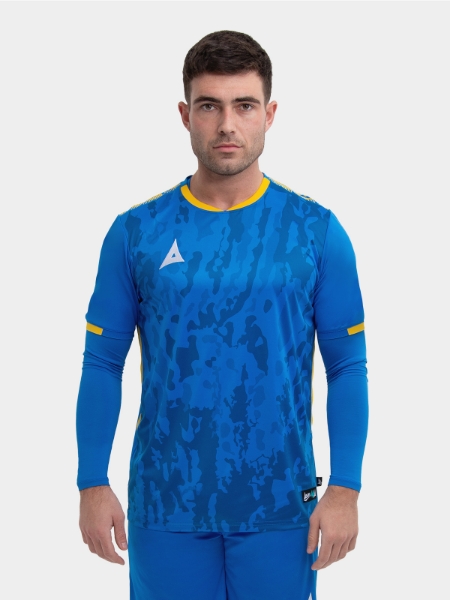 A model standing up wearing a royal blue football shirt with a compression underlay in royal blue and yellow details