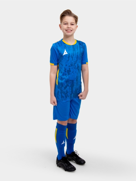 A model standing up wearing a royal blue football shirt, with yellow details