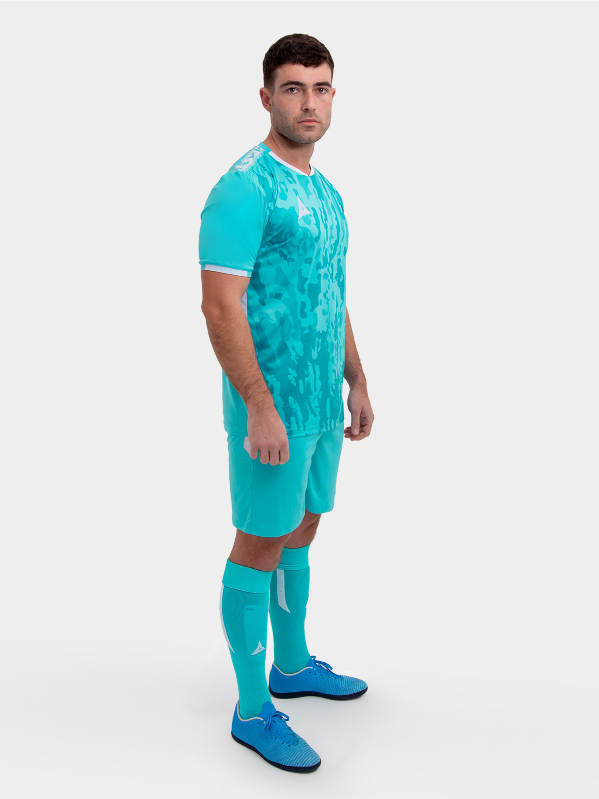 a model standing up wearing a hyper blue football shirt, hyper blue shorts and hyper blue football socks.