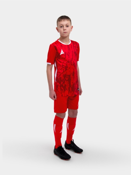 A kids football kit in red with matching red shorts and socks