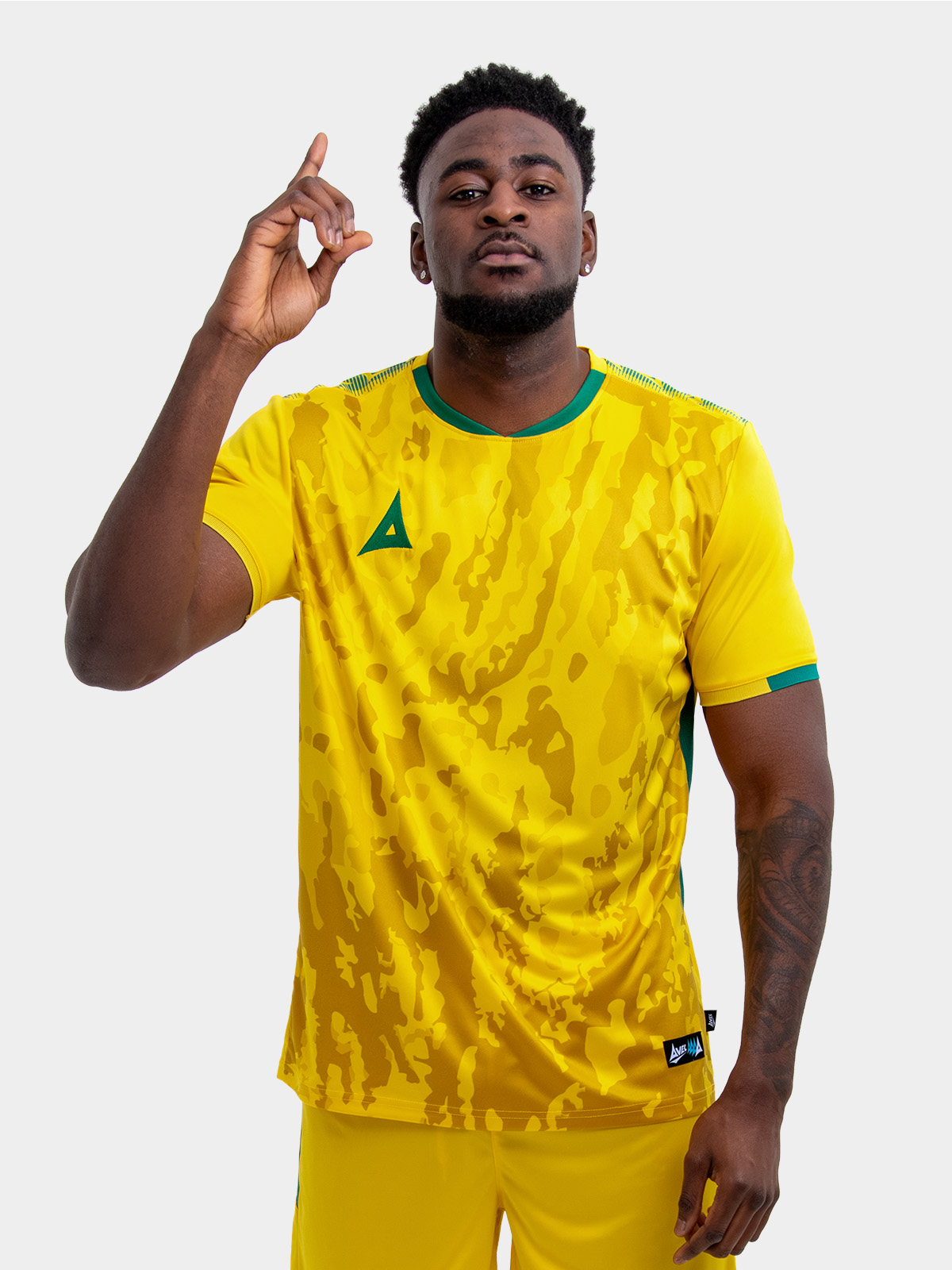 model wearing a yellow sports football training t-shirt with green accents