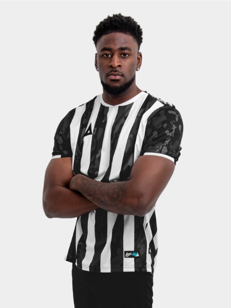 A Man wearing a Black and White striped football shirt with a camo pattern within the stripe.