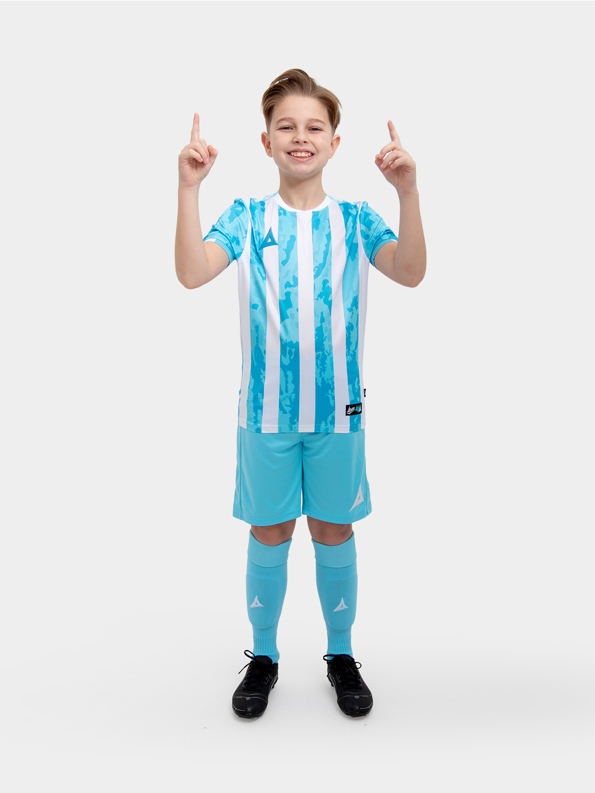 a kid is wearing a sky blue and white shirt, alongside sky blue shorts and sky blue socks