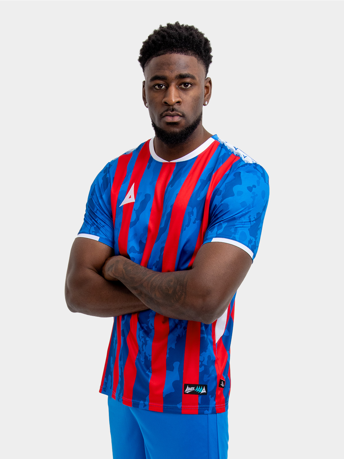 model wearing a red and royal blue stripe sports football training t-shirt.