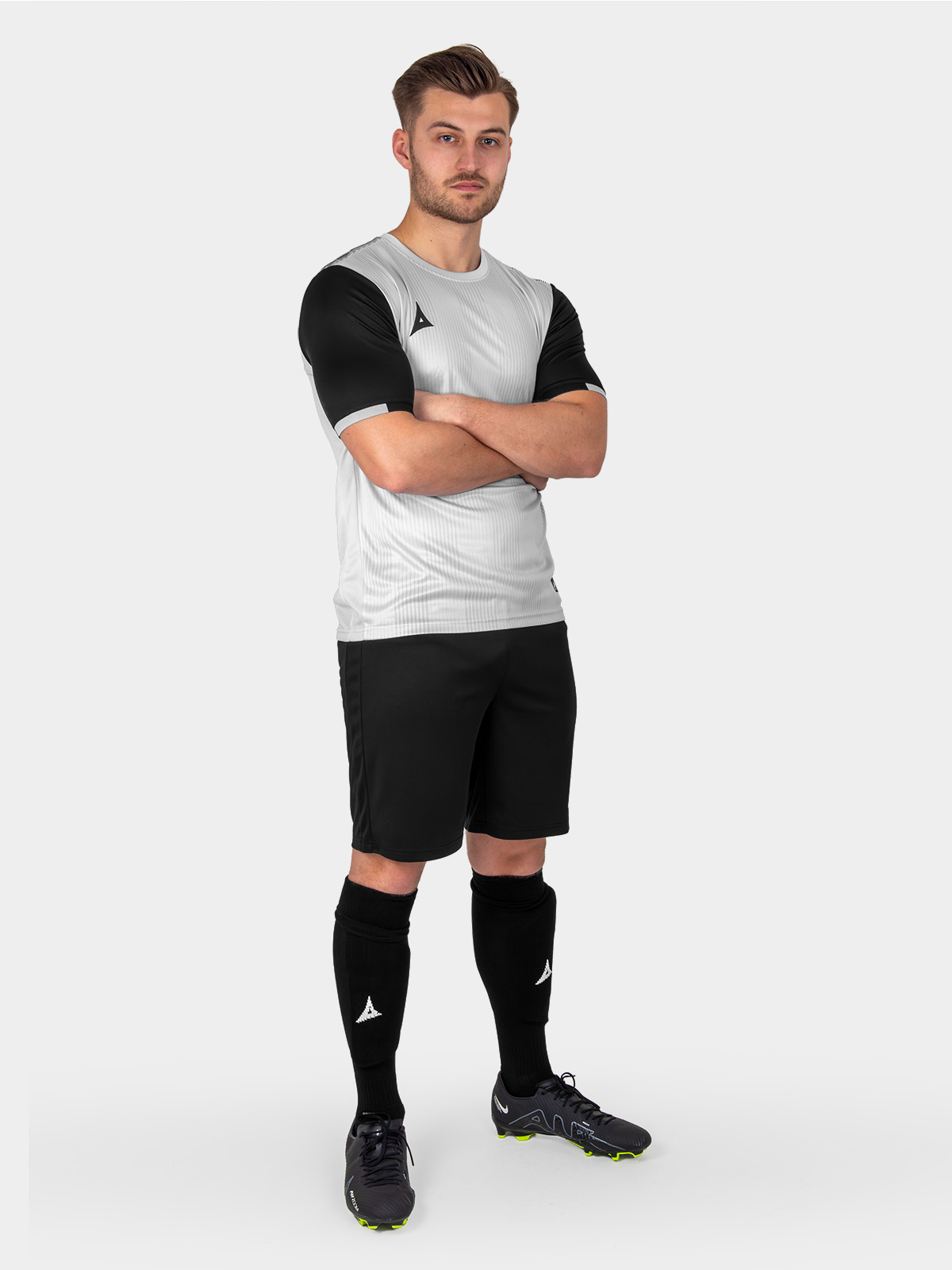 a grey football shirt is worn with black shorts and socks to match the sleeves of the top.