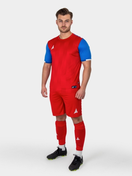 A model is wearing a red and royal blue football kit