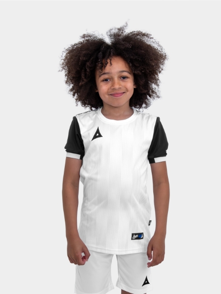 A junior footballer is wearing a children's white football shirt with black sleeves