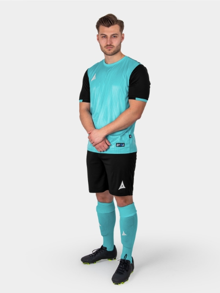 A male model wearing a light blue football shirt with a graphic print and black sleeves