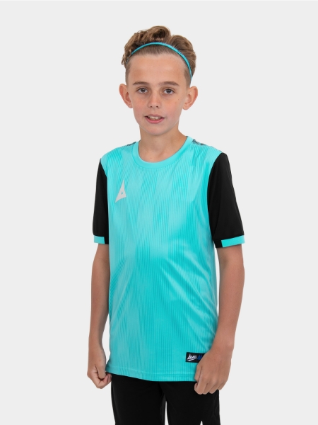 	A young child wearing a junior light blue football shirt with black sleeves