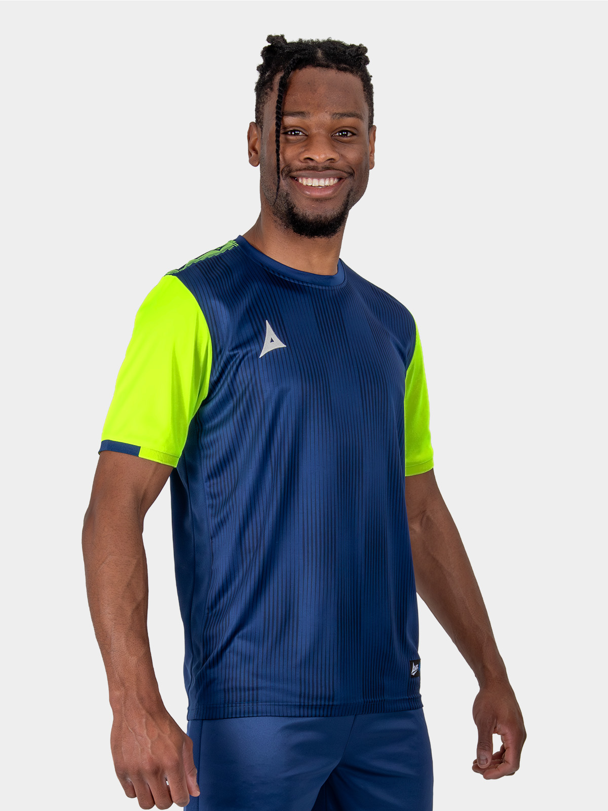 model wearing a navy blue and yellow / volt sports football training t-shirt.