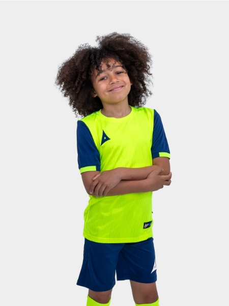 	The child in the photo is wearing a neon yellow football shirt with navy sleeves.