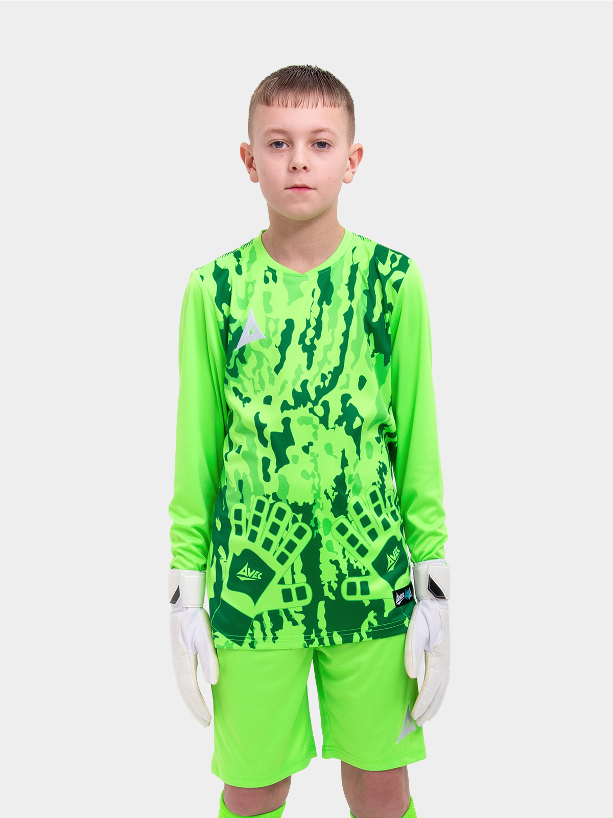 	a kid wearing a neon green goalkeeper football shirt with a camo pattern