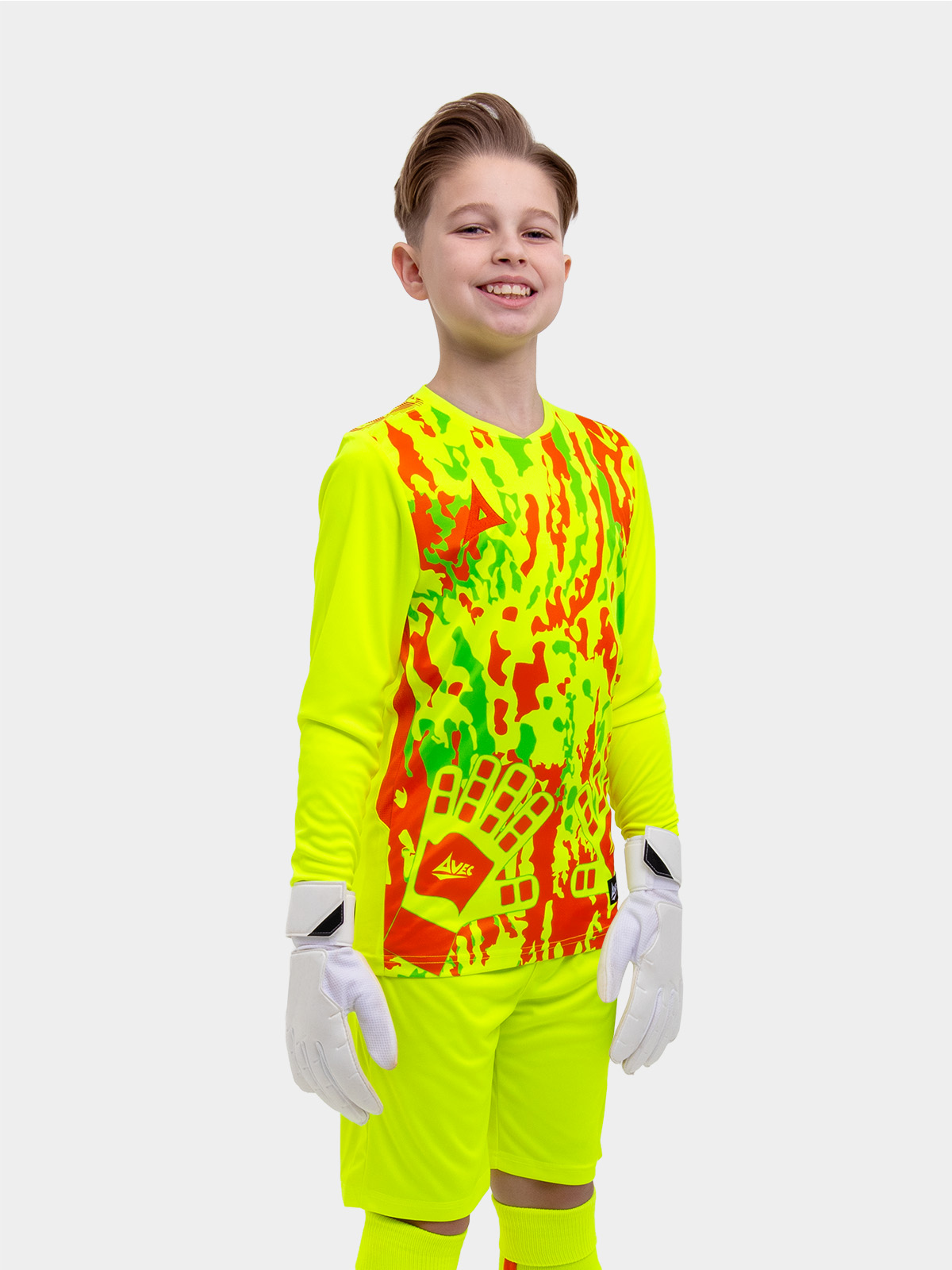 	a kid is wearing a neon yellow goalkeeper football shirt with orange panels and detailing