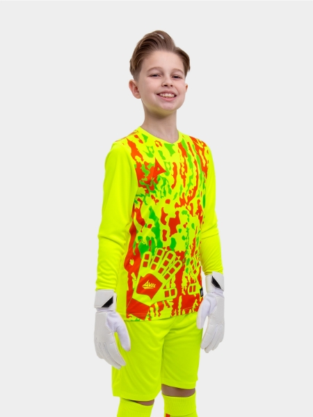 	A kid is wearing a neon yellow goalkeeper football shirt with orange panels and detailing