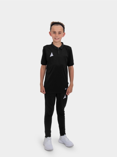 	A boy is stood wearing the Avec Focus 2 Black Tech Polo and the Avec Focus 2 Black Tech Pant ready for training