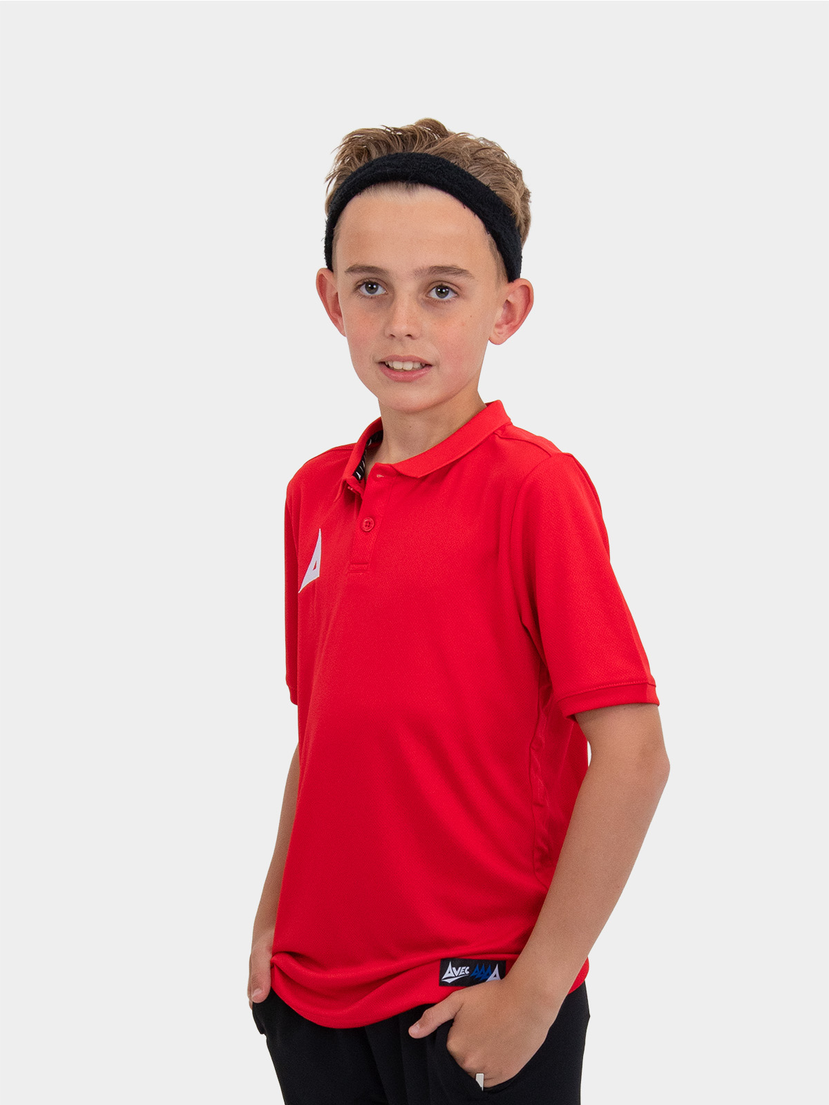 a blonde boy is wearing the avec focus 2 red tech polo and a black hairband