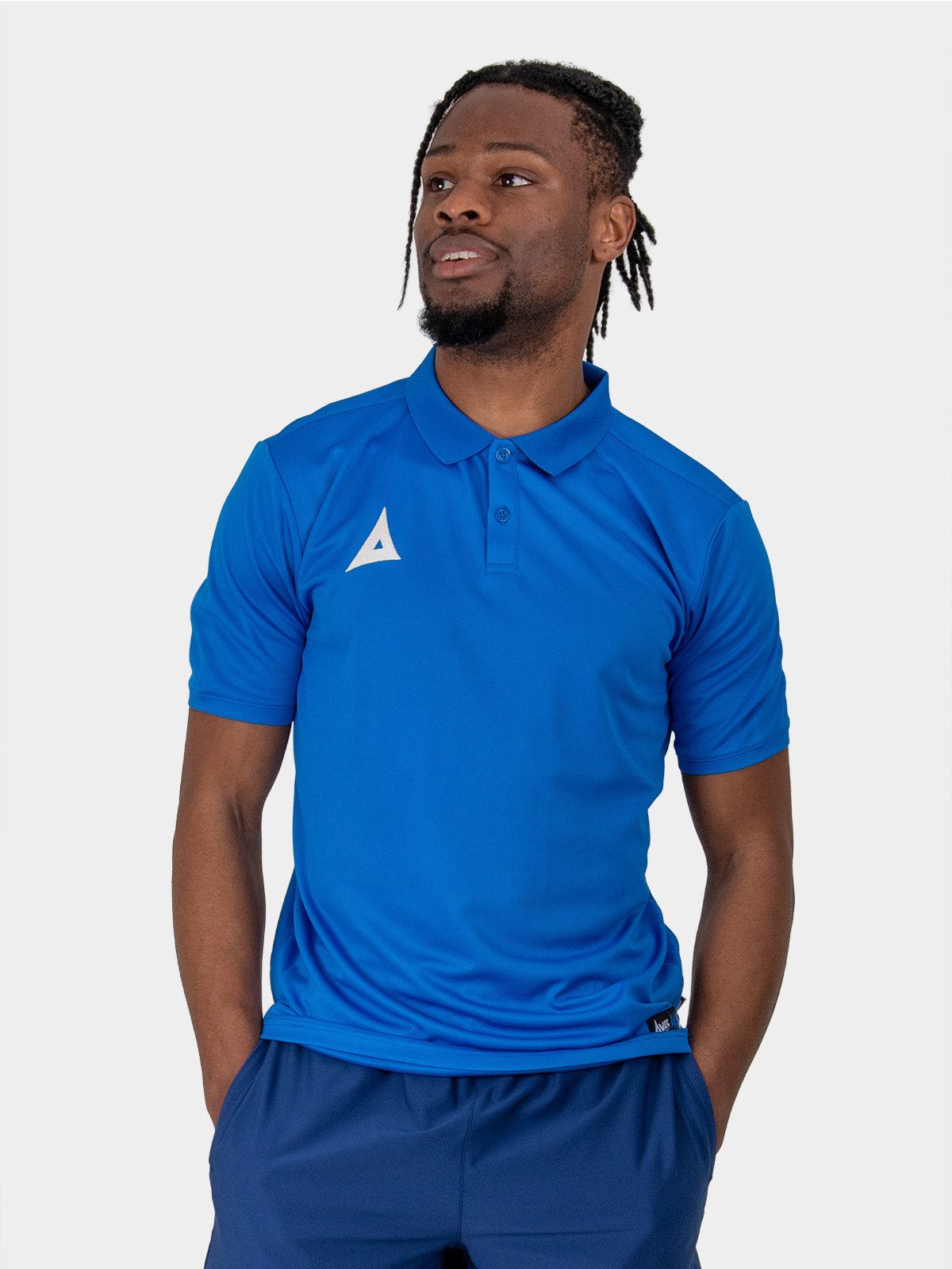 	a male model wearing the avec focus 2 royal blue tech polo, plain blue button up top