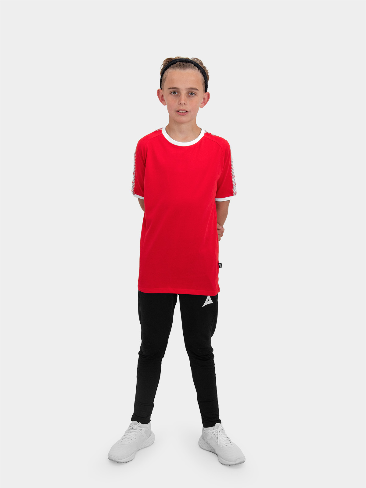 a boy is stood wearing wearing the avec evolve red t-shirt and the avec focus 2 black track pant