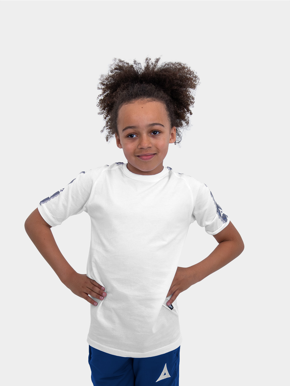 	a boy is stood wearing wearing the avec evolve white t-shirt, plain white top with navy blue sleeve detail	