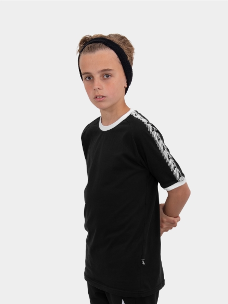A boy is stood wearing wearing the Avec Evolve Black T-Shirt, plain cotton top with sleeve detail